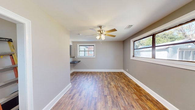 spare room featuring ceiling fan, plenty of natural light, and hardwood / wood-style flooring