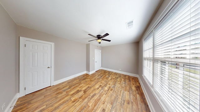 empty room featuring ceiling fan and light hardwood / wood-style floors