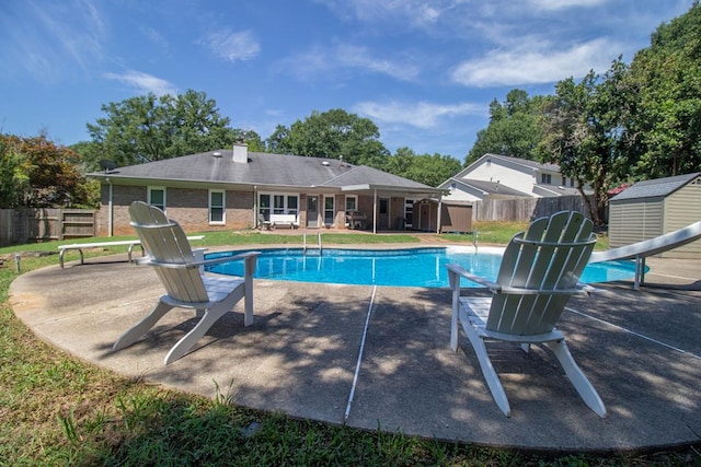7265 E Wynfield Loop, Midland, GA 31820 - view of pool featuring a storage shed, a fenced backyard, and a patio area