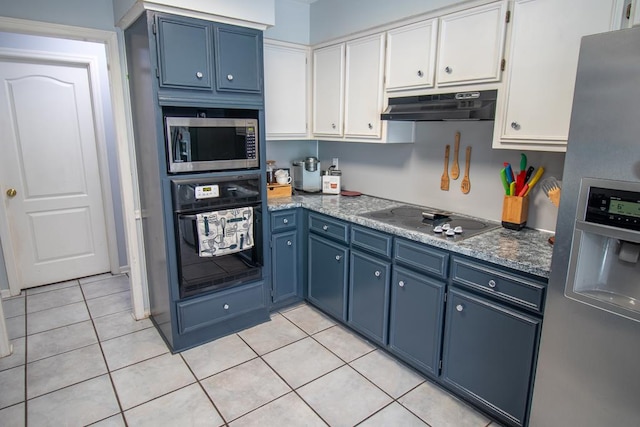 7265 E Wynfield Loop, Midland, GA 31820 - kitchen with black appliances, blue cabinets, under cabinet range hood, light tile patterned flooring, and white cabinetry