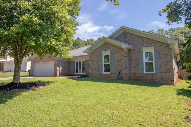 7265 E Wynfield Loop, Midland, GA 31820 - ranch-style house featuring an attached garage, brick siding, a front yard, and driveway