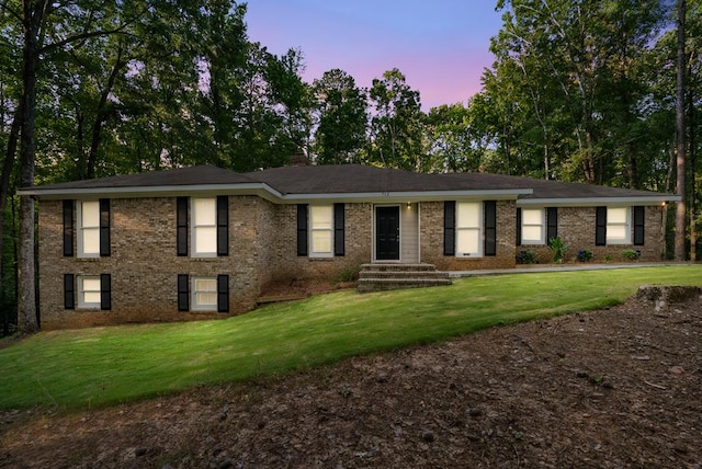 view of front of house with a yard