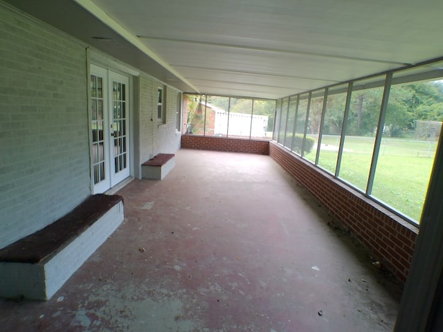 unfurnished sunroom with french doors