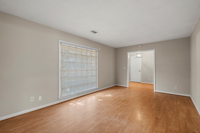 unfurnished room with visible vents, baseboards, and light wood finished floors