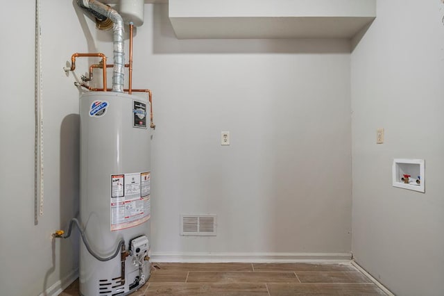 utility room with visible vents and gas water heater