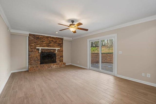 unfurnished living room with a fireplace, crown molding, baseboards, and wood finished floors