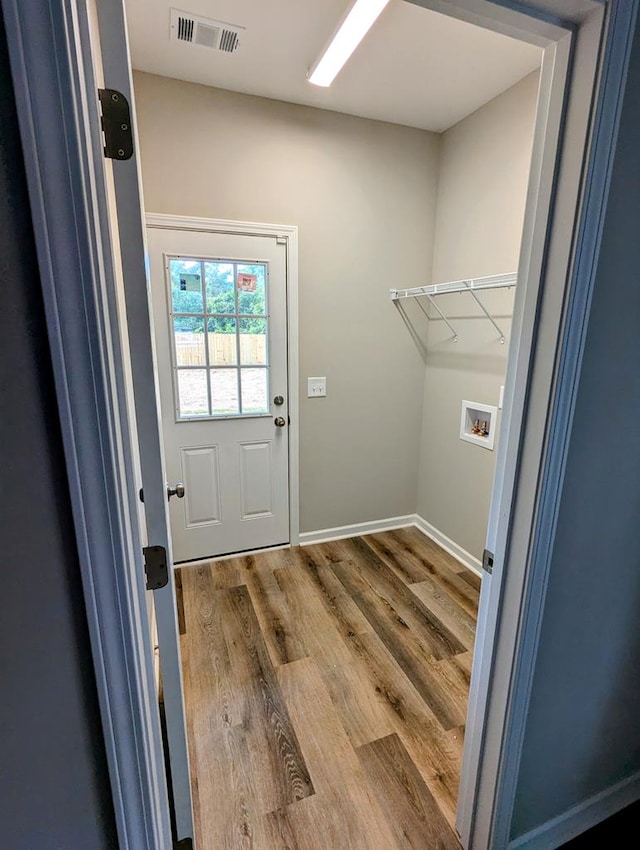 laundry area featuring washer hookup and wood-type flooring