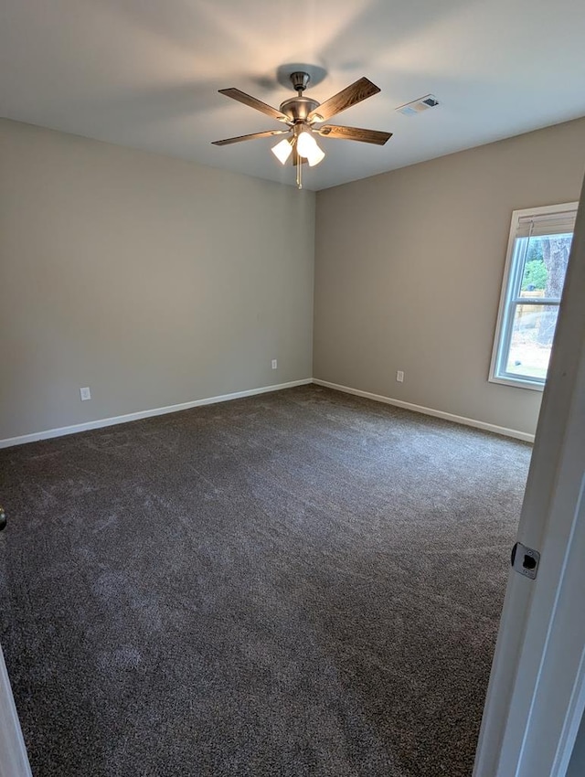 carpeted spare room with ceiling fan