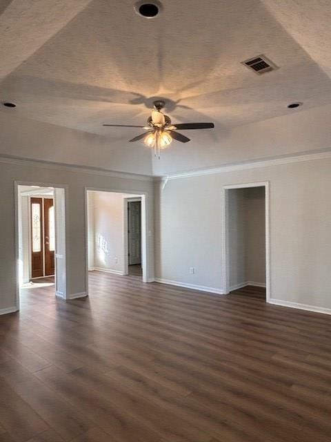 spare room with ceiling fan, dark wood-style flooring, visible vents, and baseboards