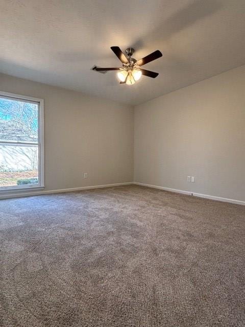 unfurnished room featuring carpet floors, baseboards, and a ceiling fan