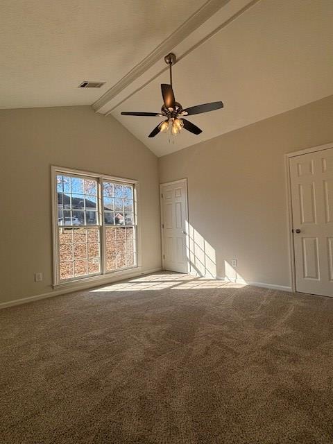 carpeted spare room with vaulted ceiling with beams, baseboards, visible vents, and a ceiling fan