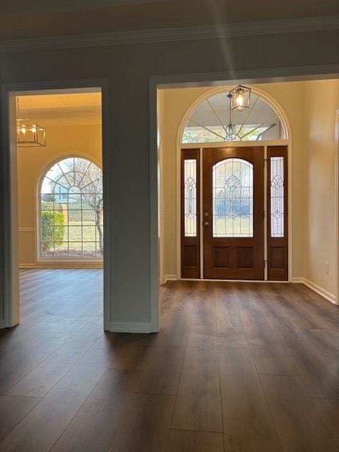 foyer featuring dark wood-style floors, baseboards, and crown molding