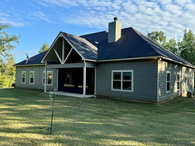 back of property featuring a yard and a patio