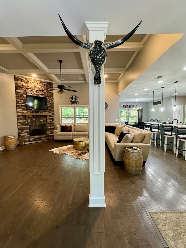 living room featuring ceiling fan, dark hardwood / wood-style flooring, and a healthy amount of sunlight