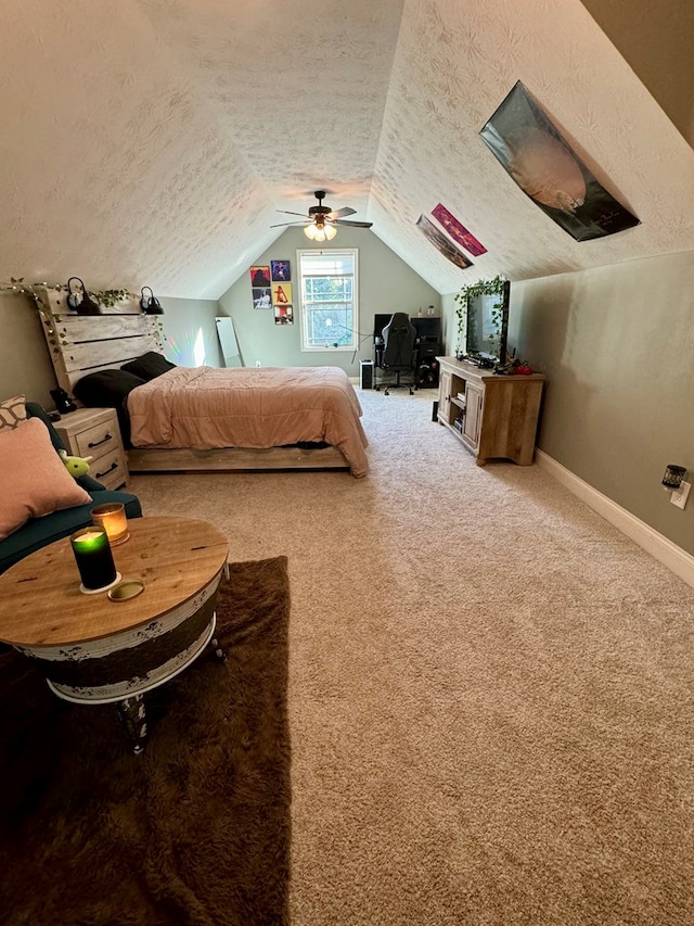 bedroom with carpet, ceiling fan, a textured ceiling, and vaulted ceiling