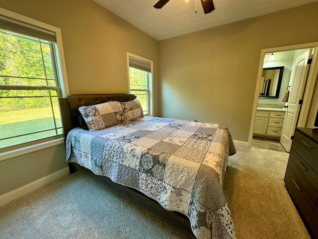 carpeted bedroom with multiple windows, a textured ceiling, connected bathroom, and ceiling fan