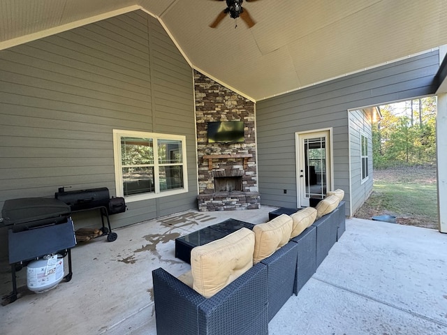 view of patio / terrace featuring an outdoor living space with a fireplace and ceiling fan