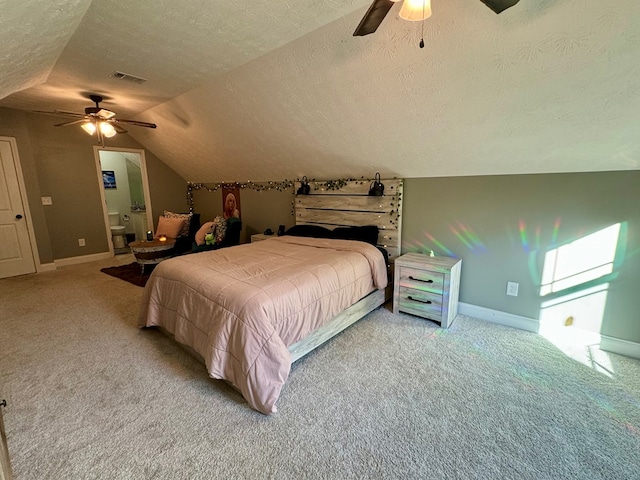 bedroom featuring a textured ceiling, carpet floors, vaulted ceiling, and ceiling fan