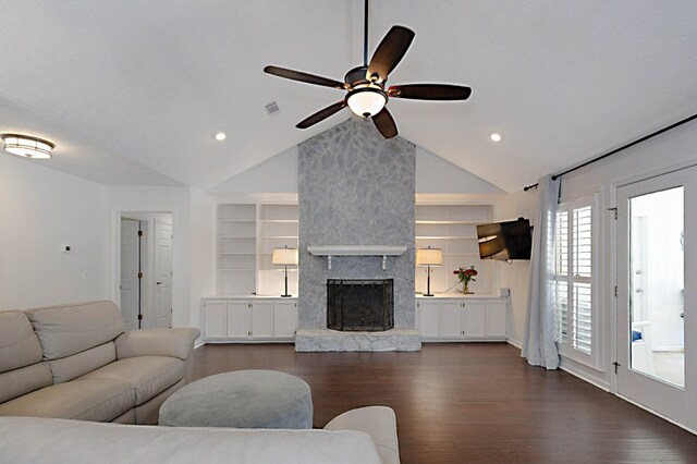7191 Otter Dr, Midland, GA 31820 - living room with ceiling fan, dark wood finished floors, built in shelves, lofted ceiling, and a stone fireplace
