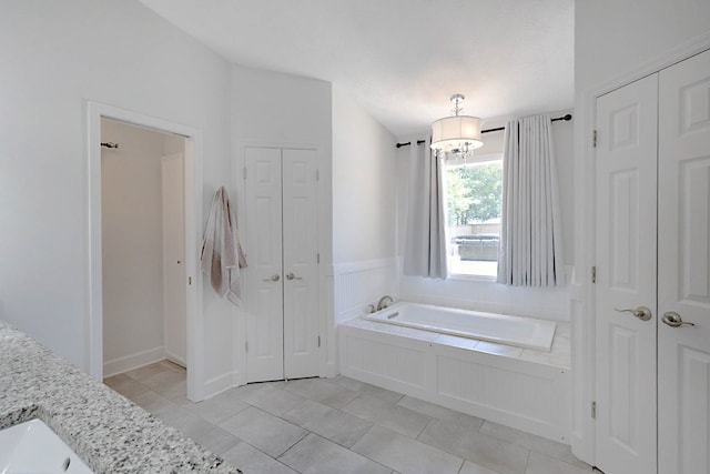 7191 Otter Dr, Midland, GA 31820 - bathroom featuring a closet, a bath, tile patterned flooring, vanity, and a chandelier