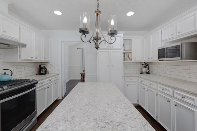 7191 Otter Dr, Midland, GA 31820 - kitchen featuring stainless steel appliances, white cabinetry, dark wood finished floors, under cabinet range hood, and recessed lighting
