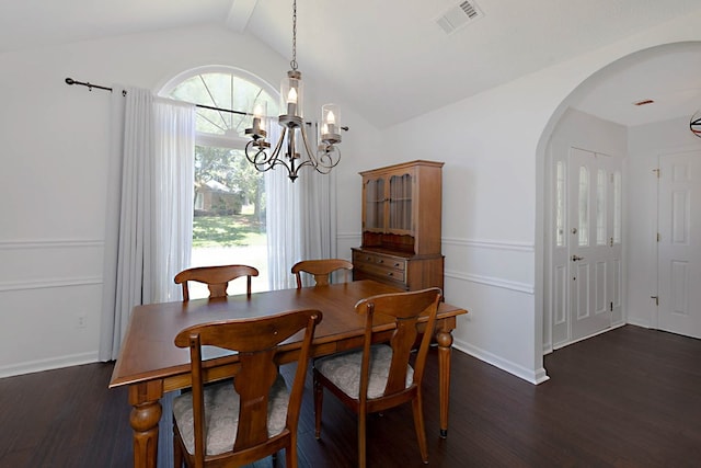 7191 Otter Dr, Midland, GA 31820 - dining area featuring lofted ceiling, arched walkways, wood finished floors, a chandelier, and baseboards