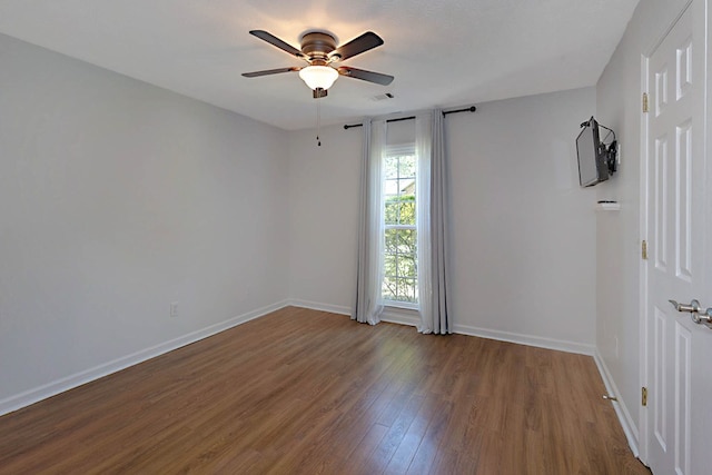 7191 Otter Dr, Midland, GA 31820 - spare room with wood finished floors, a ceiling fan, and baseboards