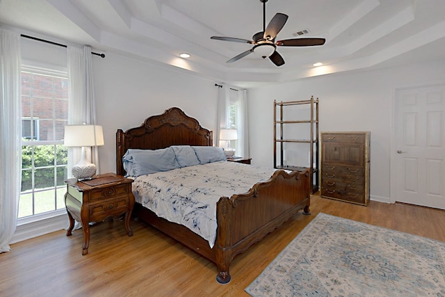7191 Otter Dr, Midland, GA 31820 - bedroom with a tray ceiling, light wood finished floors, recessed lighting, and ceiling fan