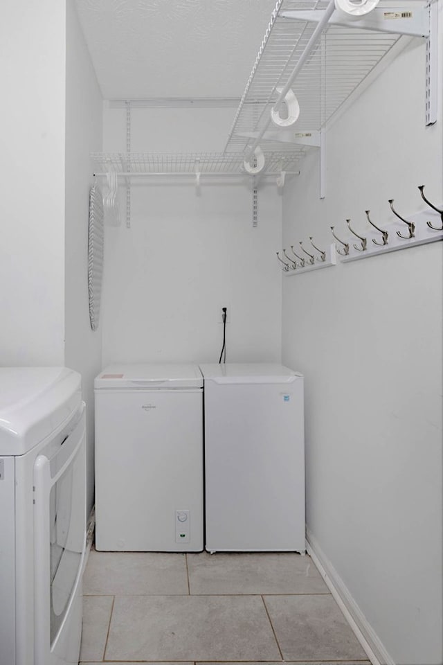 7191 Otter Dr, Midland, GA 31820 - washroom with washing machine and clothes dryer and light tile patterned flooring