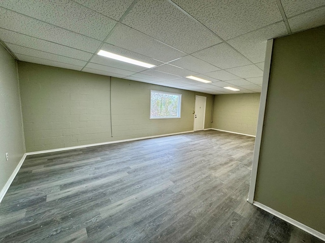 4044 Norwood Dr, Columbus, GA 31907 - below grade area with baseboards, concrete block wall, a paneled ceiling, and wood finished floors