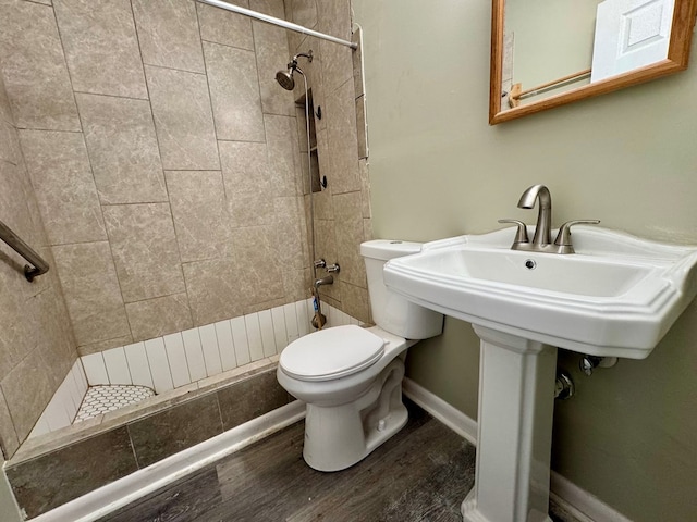 4044 Norwood Dr, Columbus, GA 31907 - bathroom featuring toilet, wood finished floors, baseboards, and tiled shower