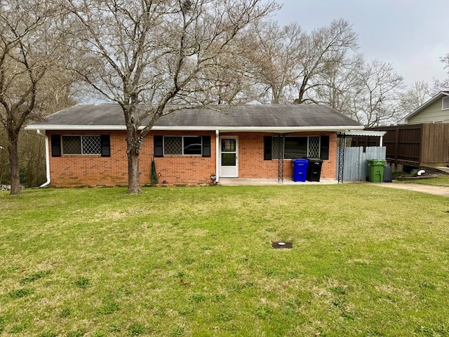 4044 Norwood Dr, Columbus, GA 31907 - back of property with a carport, a lawn, brick siding, and fence