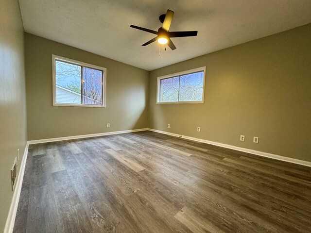 4044 Norwood Dr, Columbus, GA 31907 - empty room with a healthy amount of sunlight, a ceiling fan, baseboards, and dark wood-style flooring