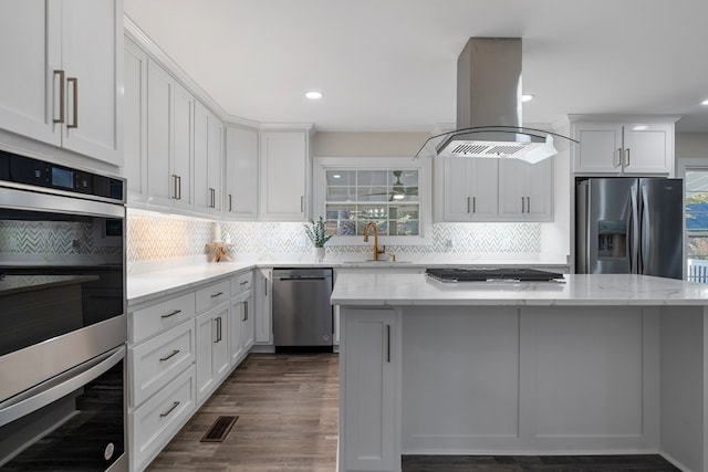 7209 Lullwater Rd, Columbus, GA 31904 - kitchen with stainless steel appliances, island range hood, plenty of natural light, backsplash, and recessed lighting