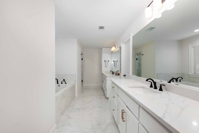 10312 Emerson Way, Midland, GA 31822 - full bathroom featuring marble finish floors, two vanities, a bath, and recessed lighting