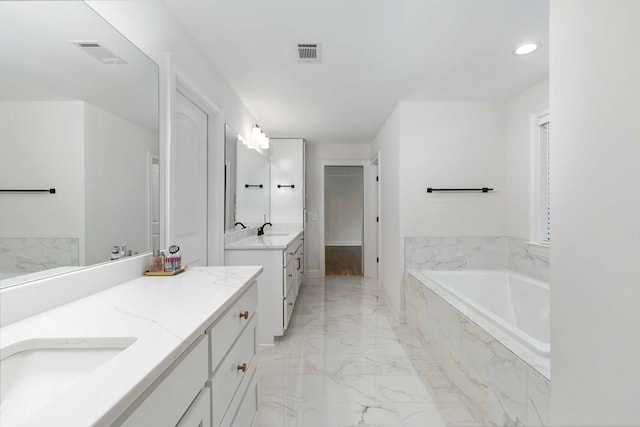 10312 Emerson Way, Midland, GA 31822 - full bath with marble finish floors, two vanities, a garden tub, and recessed lighting