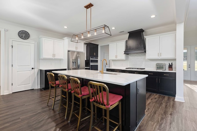 10312 Emerson Way, Midland, GA 31822 - kitchen featuring crown molding, dark wood-style floors, a kitchen breakfast bar, appliances with stainless steel finishes, and white cabinetry