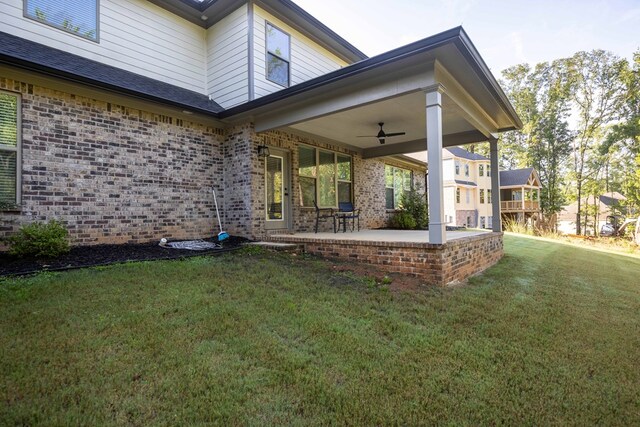 10312 Emerson Way, Midland, GA 31822 - view of property exterior with brick siding, a ceiling fan, a yard, and a patio