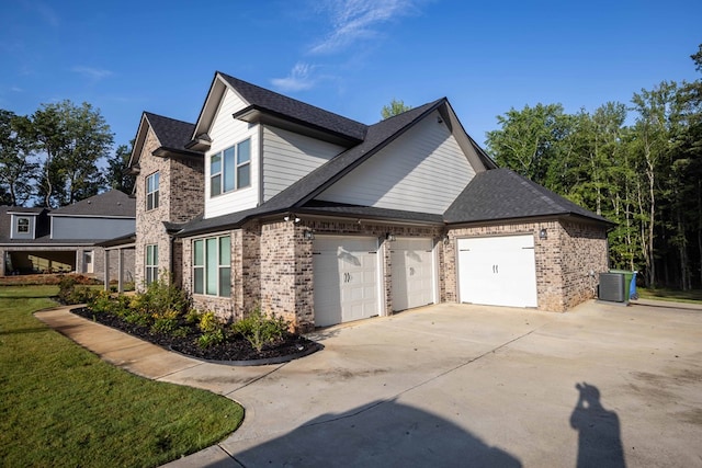 10312 Emerson Way, Midland, GA 31822 - view of side of property featuring a shingled roof, concrete driveway, brick siding, and a garage