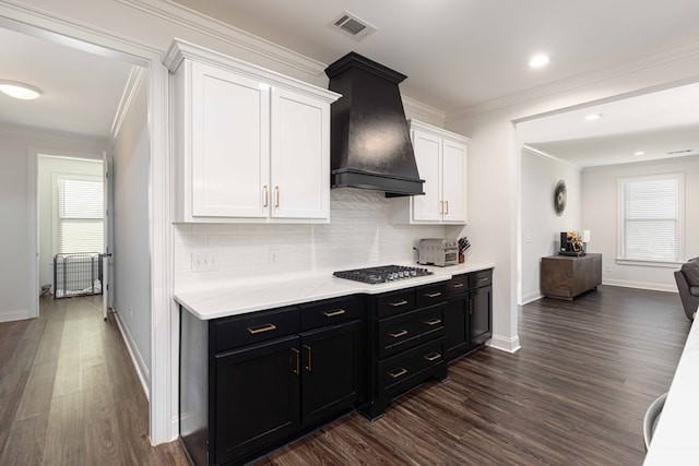 10312 Emerson Way, Midland, GA 31822 - kitchen featuring white cabinets, dark cabinets, dark wood-type flooring, decorative backsplash, and crown molding