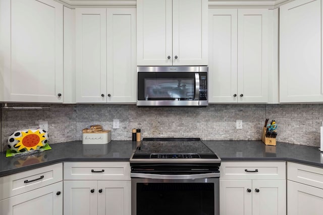 7514 Garrett Rd, Midland, GA 31820 - kitchen with stainless steel appliances, dark countertops, and white cabinetry