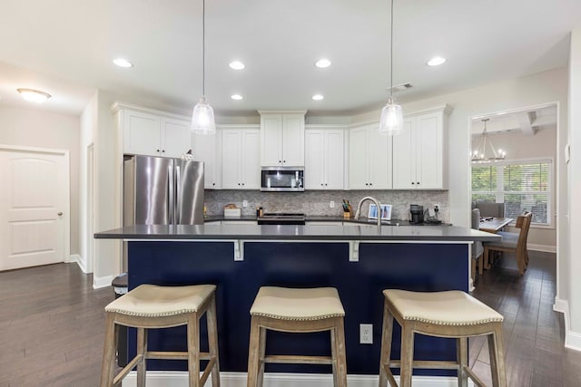 7514 Garrett Rd, Midland, GA 31820 - kitchen with stainless steel appliances, dark countertops, decorative backsplash, white cabinets, and recessed lighting