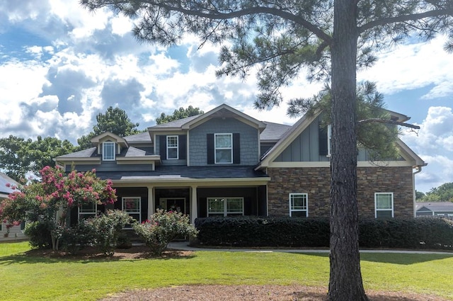 7514 Garrett Rd, Midland, GA 31820 - craftsman inspired home with a front lawn, stone siding, and board and batten siding