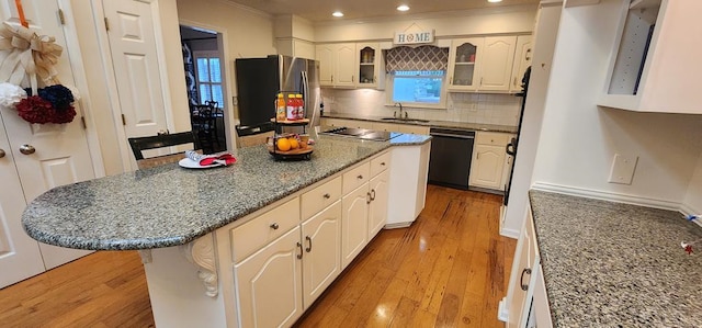 7400 Standing Boy Rd, Columbus, GA 31904 - kitchen with freestanding refrigerator, dishwasher, electric cooktop, decorative backsplash, and glass insert cabinets