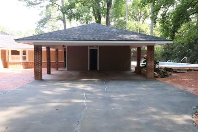 7400 Standing Boy Rd, Columbus, GA 31904 - garage with asphalt driveway, an outdoor pool, and an attached carport