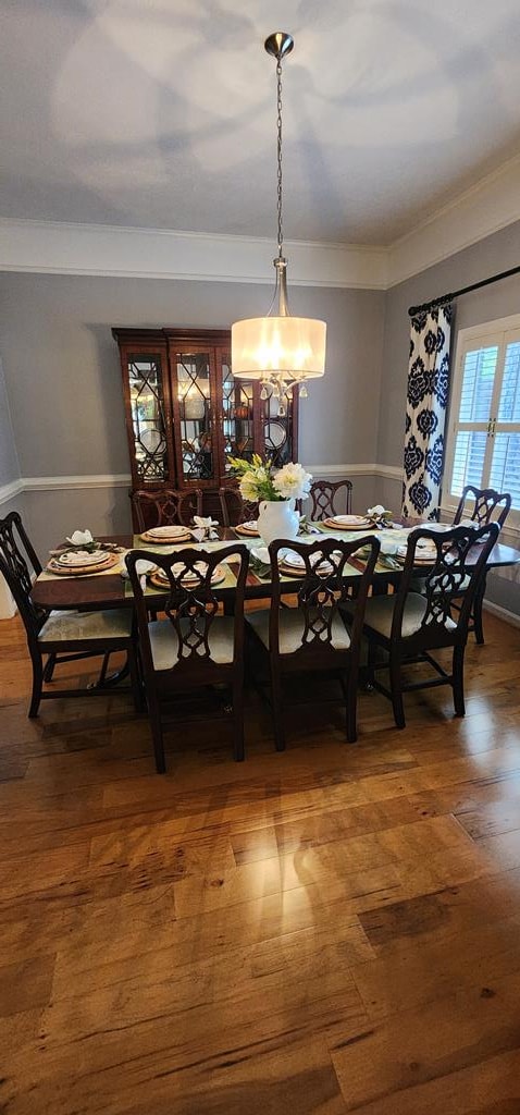 7400 Standing Boy Rd, Columbus, GA 31904 - dining room with wood finished floors, a chandelier, and crown molding