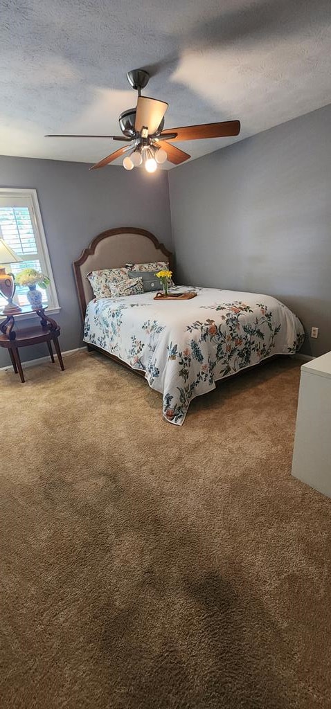 7400 Standing Boy Rd, Columbus, GA 31904 - bedroom featuring carpet flooring, a textured ceiling, and a ceiling fan