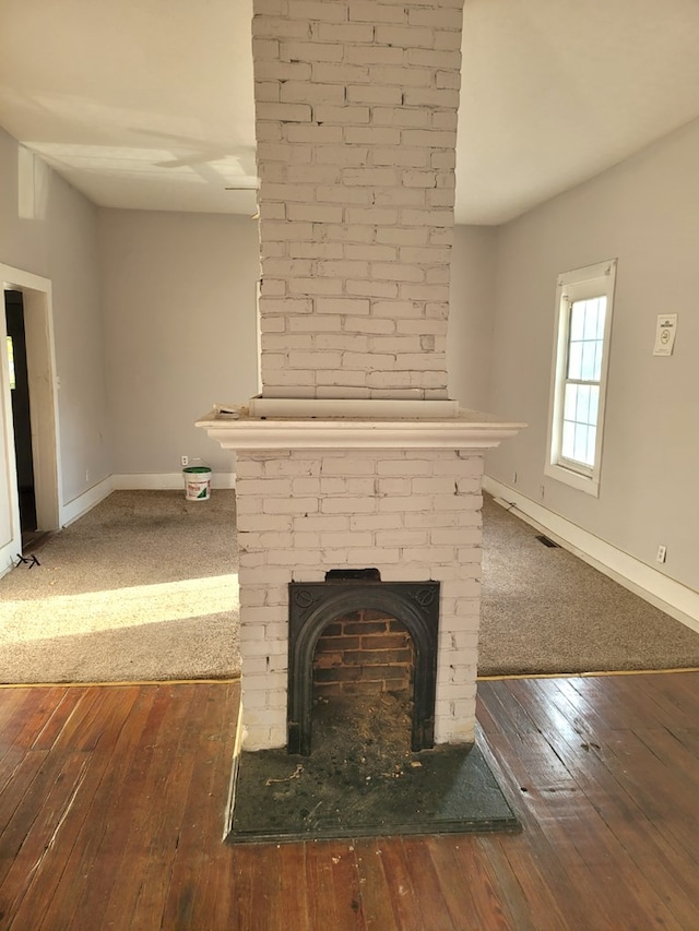 details with a fireplace, baseboards, and wood finished floors