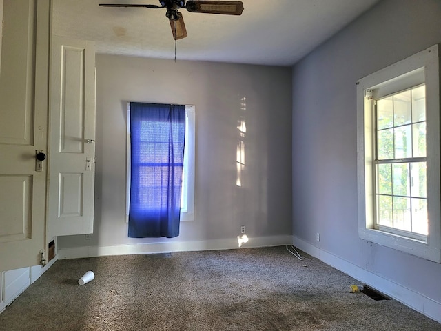 empty room featuring carpet floors, baseboards, and a ceiling fan