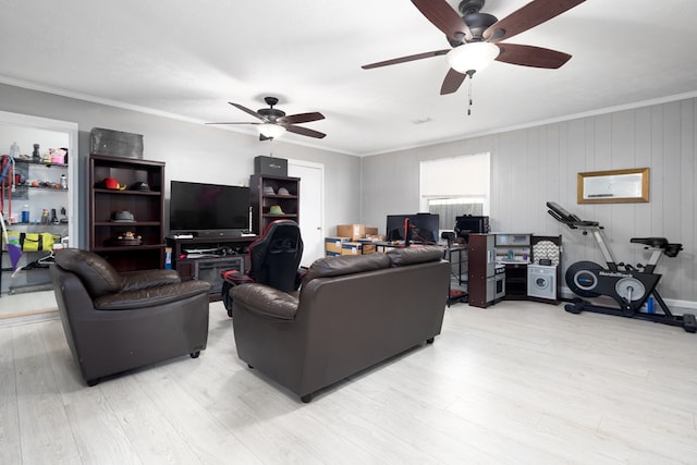 living room featuring light hardwood / wood-style flooring, ornamental molding, and wood walls